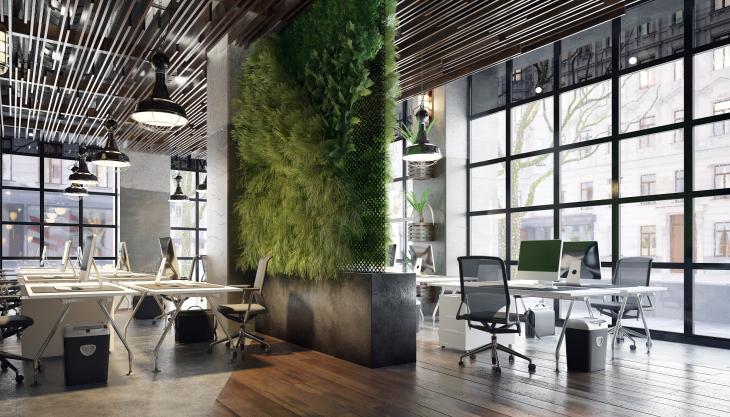 Ein Loft-artiger offener Büroraum, in dessen Mitte eine Wand mit vertikalem Garten wächst.