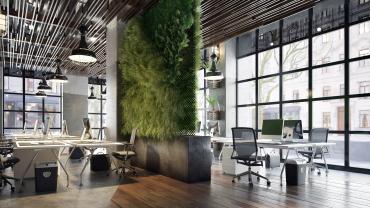 Ein Loft-artiger offener Büroraum, in dessen Mitte eine Wand mit vertikalem Garten wächst.